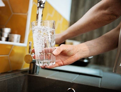 Woman filling up a glass of water