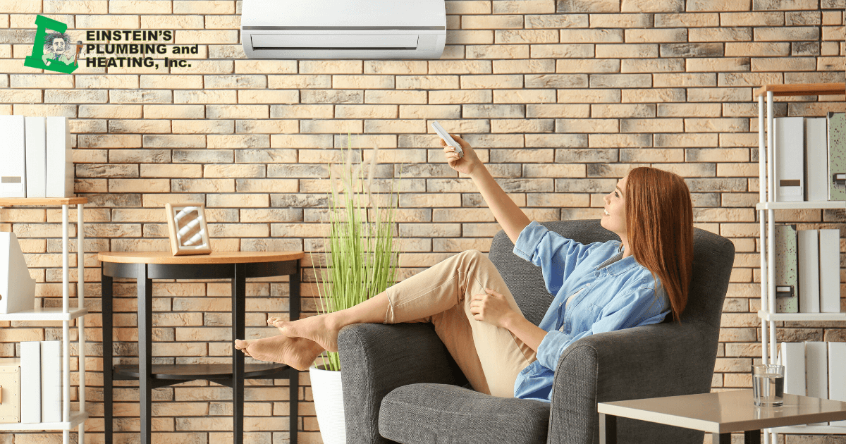 woman turning on ductless mini split air conditioner